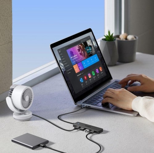 Amazon Basics 8-in-1 USB Hub shown beside a compatible laptop